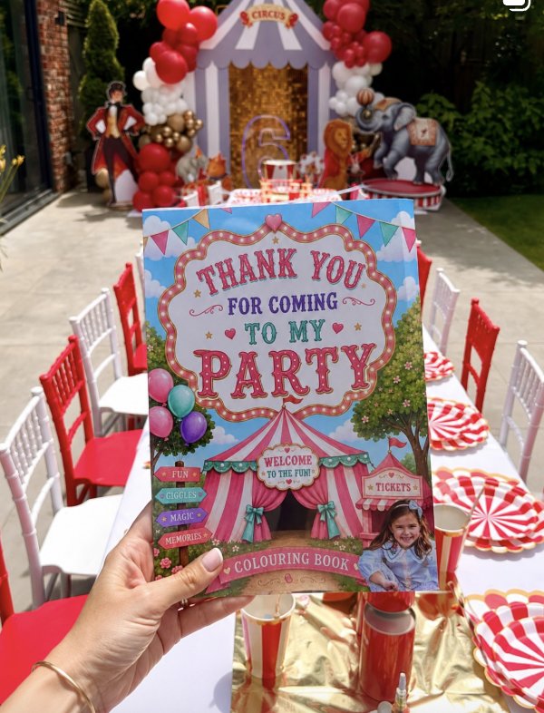 A personalised circus colouring book held up at a party